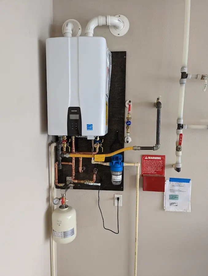 Professional plumber installing copper piping in a Carlisle home